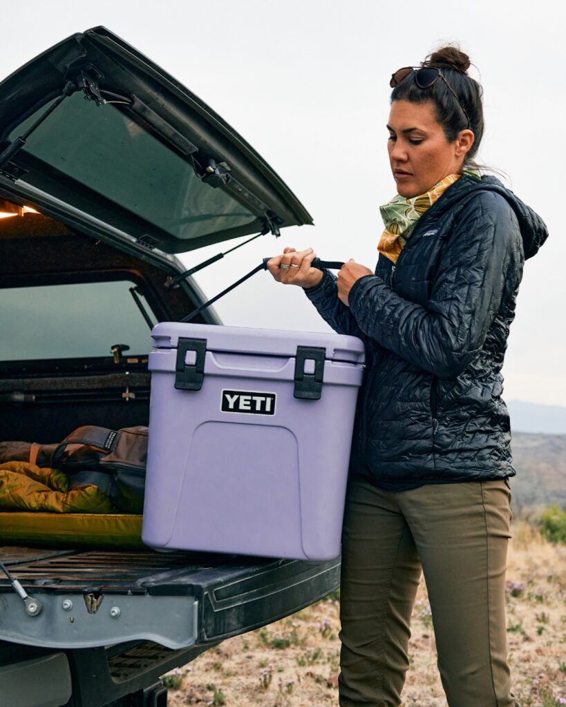 Lilac Roadie 24 Cooler, women putting it into boot of vehicle